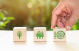 ISO 14001 banner picture, human hand moving blocks that have environment related icon pictures